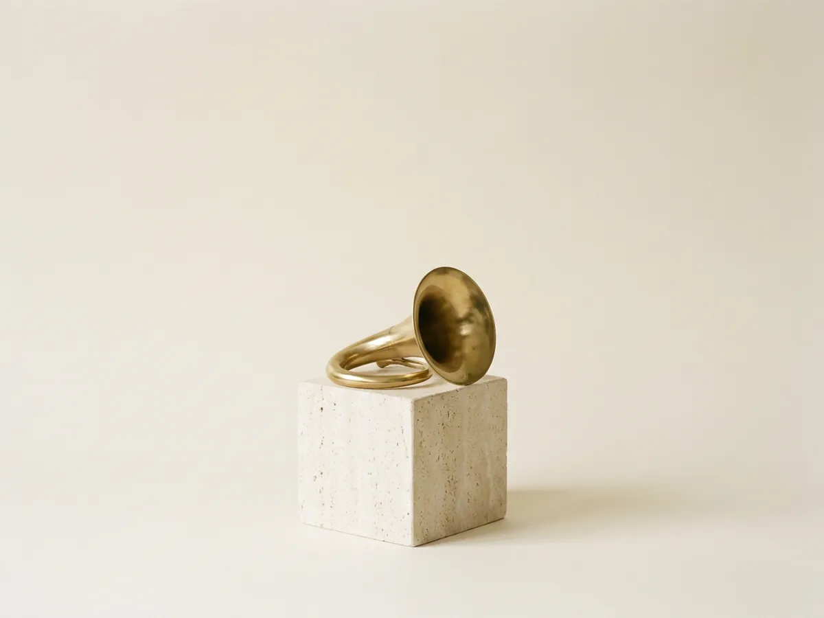 Bocina de gramófono de latón sobre cubo de travertino